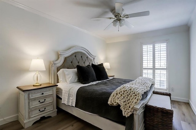 bedroom with ceiling fan, ornamental molding, and dark wood-type flooring