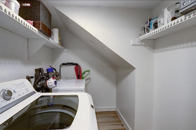 washroom with separate washer and dryer and light wood-type flooring