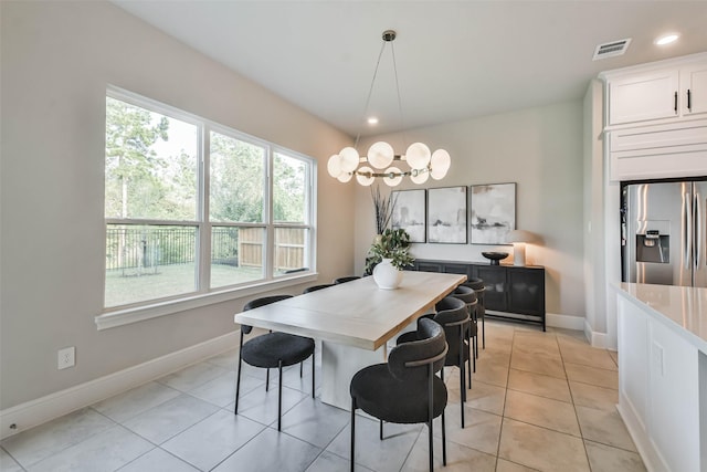 dining space with an inviting chandelier, plenty of natural light, and light tile patterned flooring