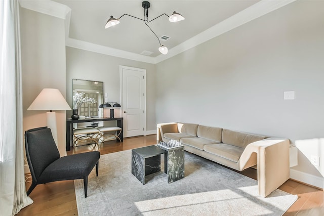 living room with ornamental molding and hardwood / wood-style flooring