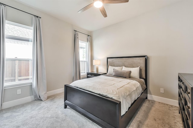 bedroom with ceiling fan and light carpet