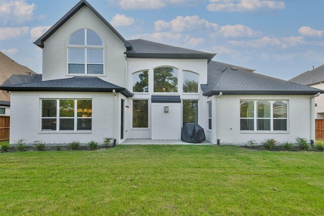 rear view of property with a patio area and a yard