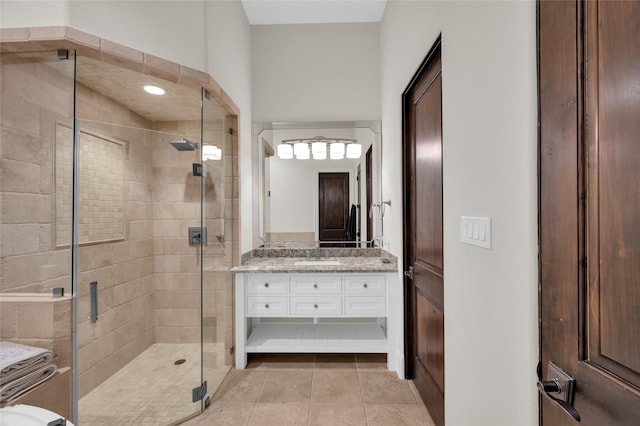 bathroom featuring walk in shower, tile patterned floors, and vanity