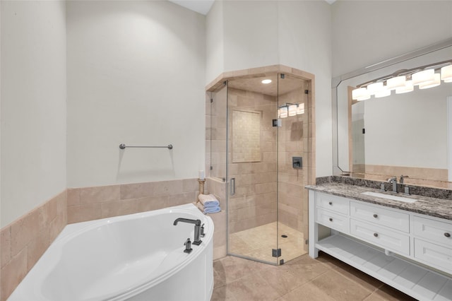 bathroom featuring independent shower and bath, tile patterned flooring, and vanity