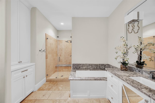 bathroom featuring vanity and separate shower and tub