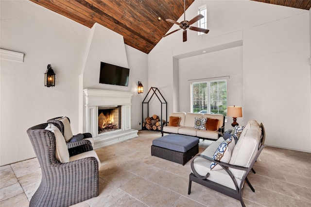 living room with exterior fireplace, high vaulted ceiling, ceiling fan, and wooden ceiling