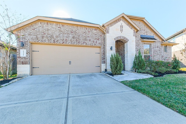 view of front of house featuring a front yard and a garage