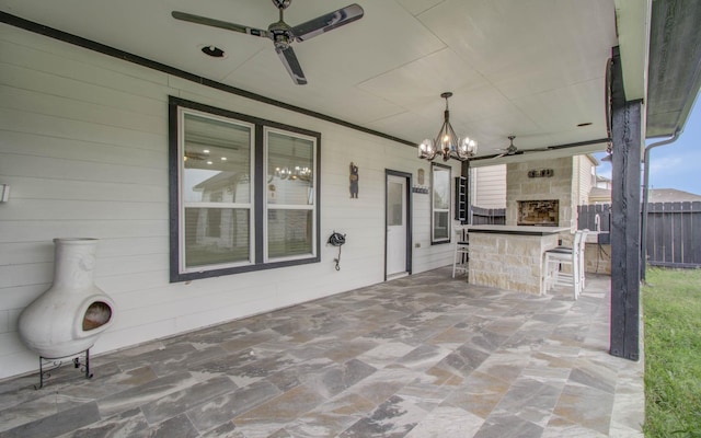 view of patio / terrace featuring a bar and exterior fireplace