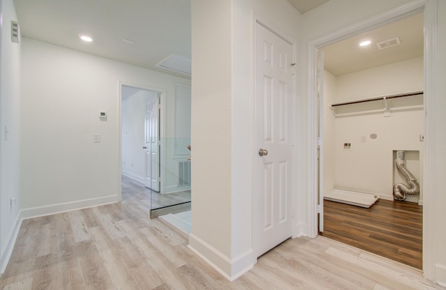 corridor with light hardwood / wood-style floors