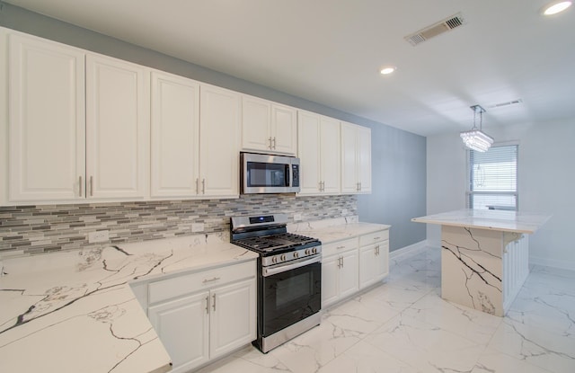 kitchen featuring light stone countertops, stainless steel appliances, tasteful backsplash, decorative light fixtures, and white cabinets