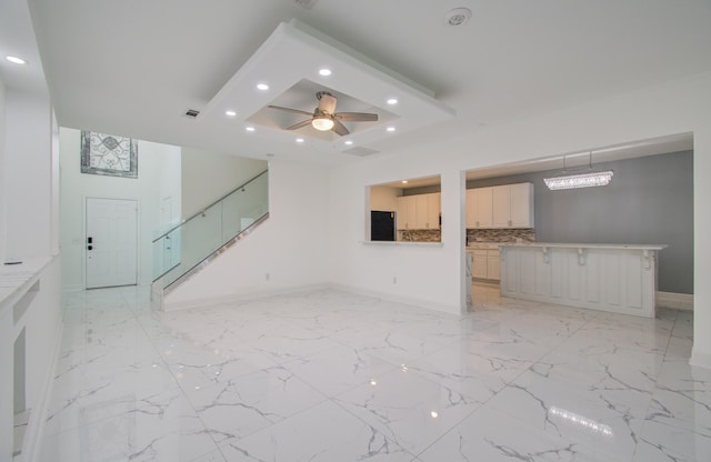 unfurnished living room featuring ceiling fan