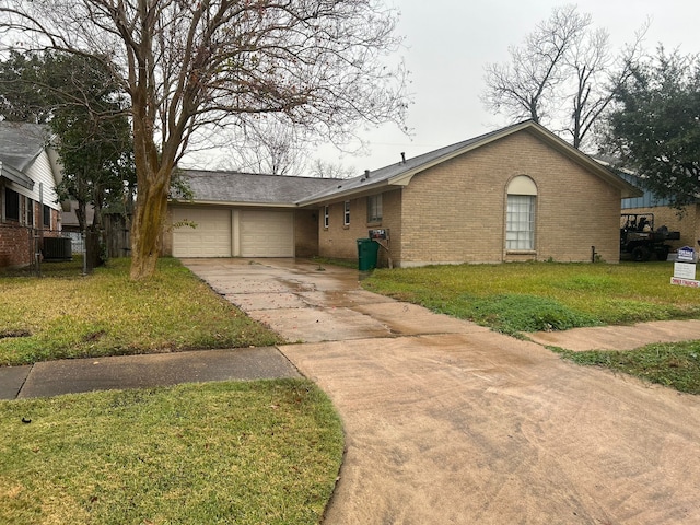 single story home with cooling unit, a front lawn, and a garage