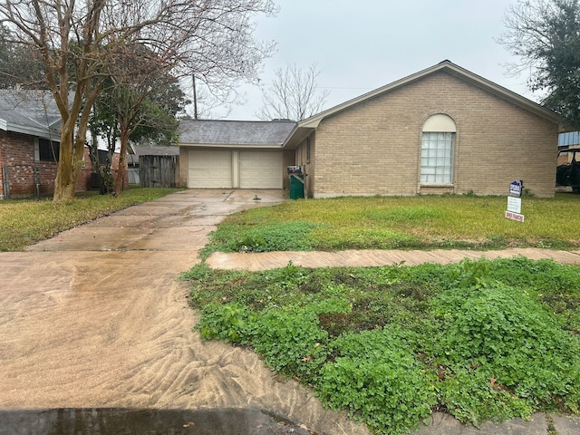 ranch-style home with a garage and a front lawn