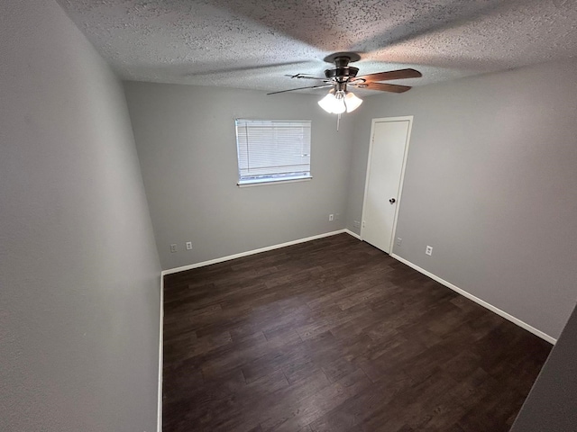 unfurnished room with a textured ceiling, dark hardwood / wood-style flooring, and ceiling fan