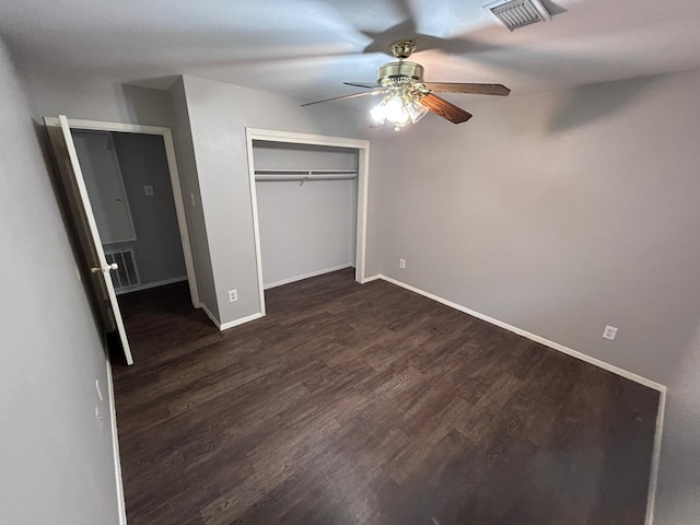 unfurnished bedroom featuring ceiling fan, dark hardwood / wood-style flooring, and a closet