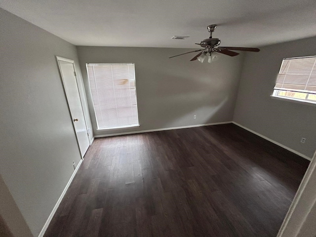 spare room with ceiling fan and dark hardwood / wood-style flooring