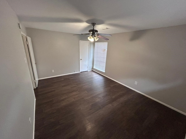 unfurnished room featuring dark hardwood / wood-style flooring and ceiling fan