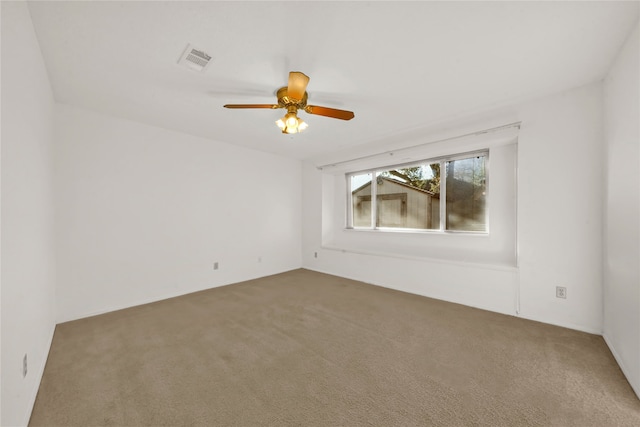 spare room with ceiling fan and carpet floors