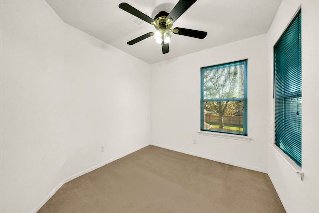 spare room with carpet and ceiling fan