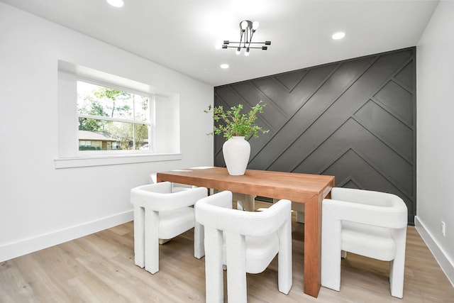 dining room with an inviting chandelier and light wood-type flooring