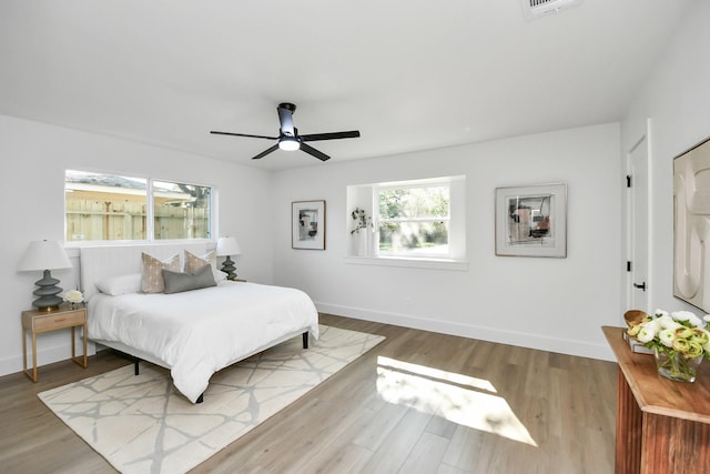 bedroom with ceiling fan and light hardwood / wood-style flooring