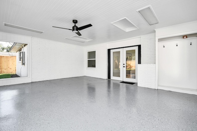 garage featuring ceiling fan, electric panel, and french doors