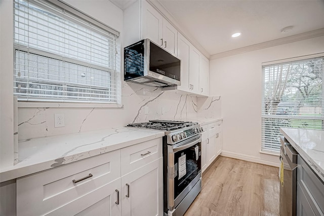 kitchen featuring white cabinetry, decorative backsplash, light stone countertops, and stainless steel appliances