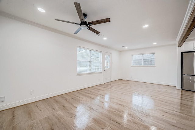 unfurnished living room with ceiling fan, light hardwood / wood-style floors, and ornamental molding