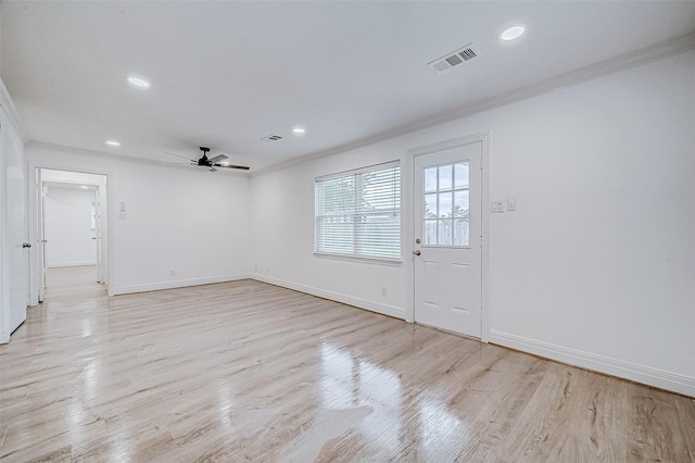 unfurnished room featuring light hardwood / wood-style floors, ceiling fan, and crown molding