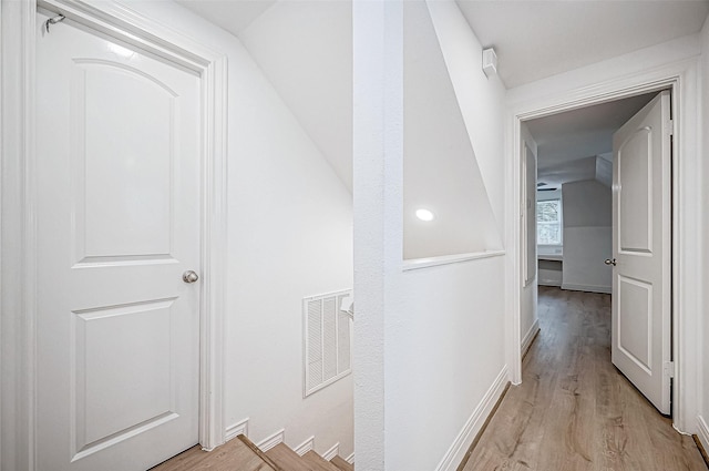 corridor with light hardwood / wood-style flooring