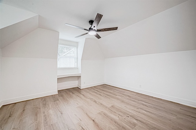 additional living space featuring ceiling fan, light hardwood / wood-style floors, and vaulted ceiling