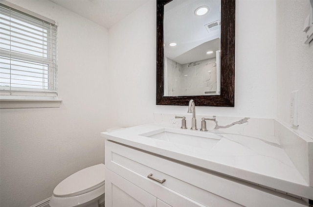 bathroom featuring vanity and toilet