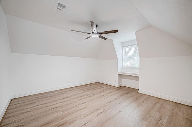 additional living space featuring ceiling fan, light hardwood / wood-style flooring, and vaulted ceiling