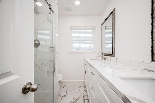 bathroom featuring toilet, vanity, and walk in shower