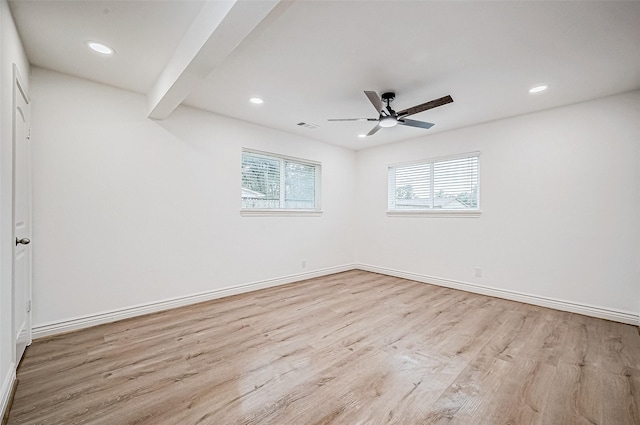 unfurnished room featuring beamed ceiling, ceiling fan, and light hardwood / wood-style floors