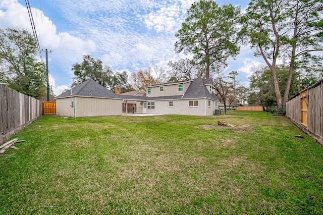 rear view of house with a lawn and a patio