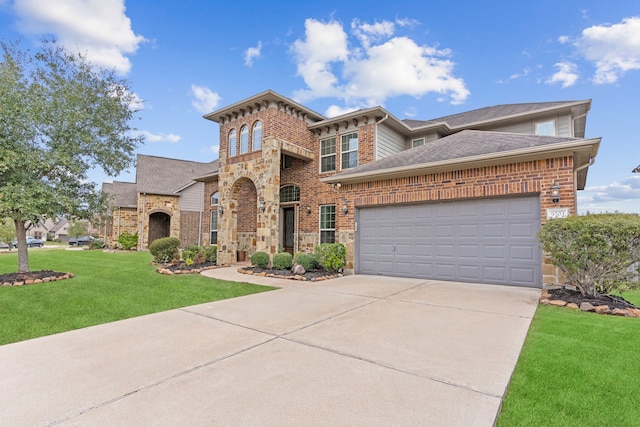 view of front of home with driveway, stone siding, an attached garage, a front lawn, and brick siding