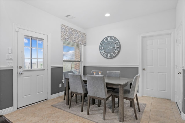 dining space with light tile patterned flooring, visible vents, and baseboards