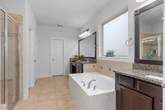 bathroom with tile patterned flooring, plus walk in shower, and vanity