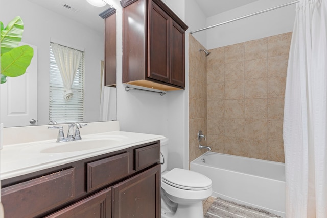 bathroom with toilet, shower / tub combo, visible vents, and vanity