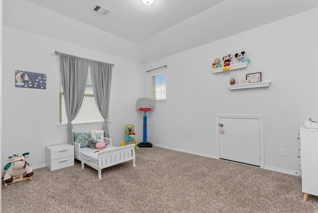 carpeted bedroom with a nursery area, multiple windows, and vaulted ceiling