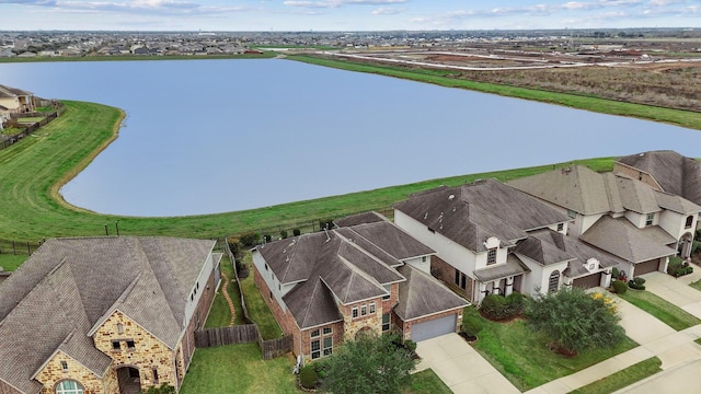 drone / aerial view featuring a water view and a residential view