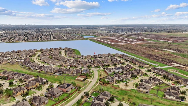 drone / aerial view featuring a water view and a residential view