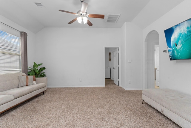 carpeted living area featuring arched walkways, ceiling fan, lofted ceiling, and visible vents