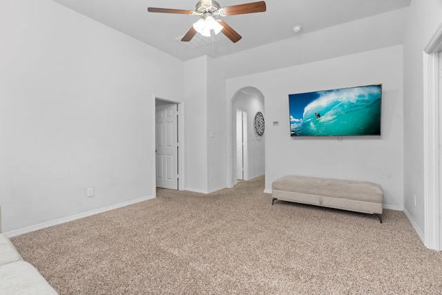 living area featuring ceiling fan and carpet