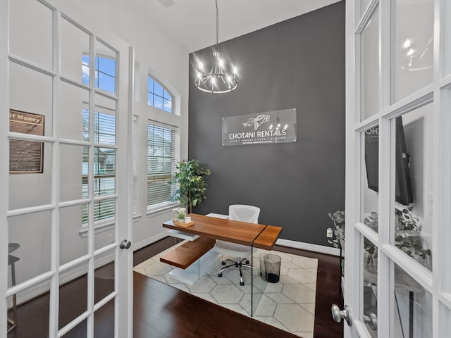 office area with a notable chandelier, dark wood-type flooring, and french doors