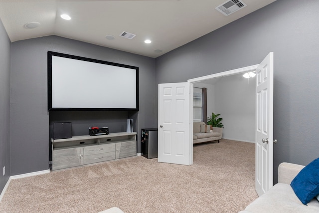 home theater with lofted ceiling, carpet, and visible vents