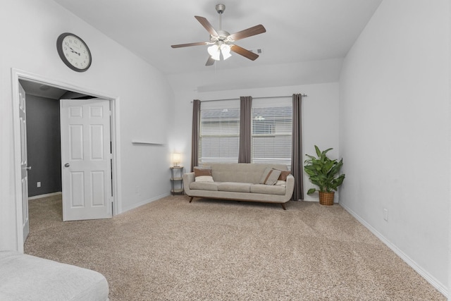 living area featuring carpet floors, baseboards, a ceiling fan, and lofted ceiling