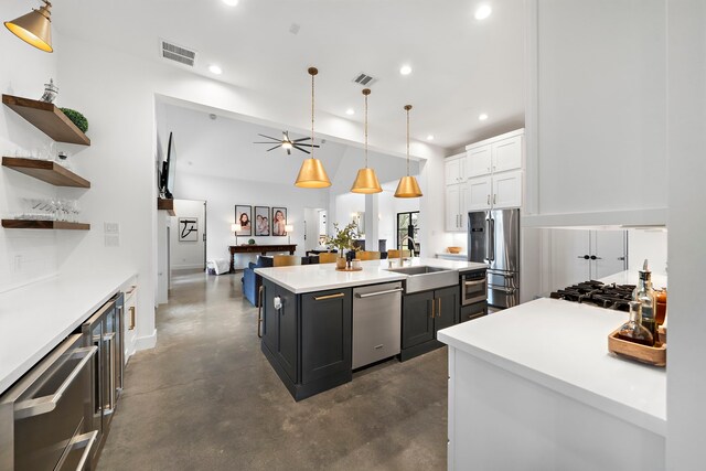 4103 Lea Ln, Fulshear, TX 77406 - kitchen with appliances with stainless steel finishes, white cabinetry, a kitchen island with sink, recessed lighting, and concrete floors