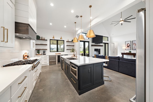4103 Lea Ln, Fulshear, TX 77406 - kitchen with finished concrete flooring, stainless steel appliances, open shelves, white cabinets, and light countertops